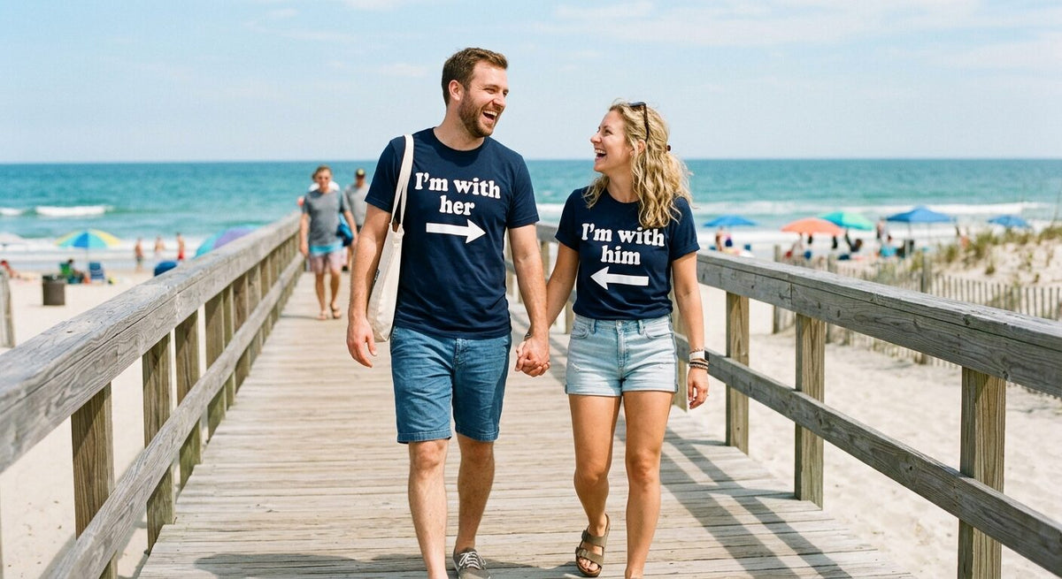 Couple on a beach boardwalk in matching I'm with her and I'm with him shirts